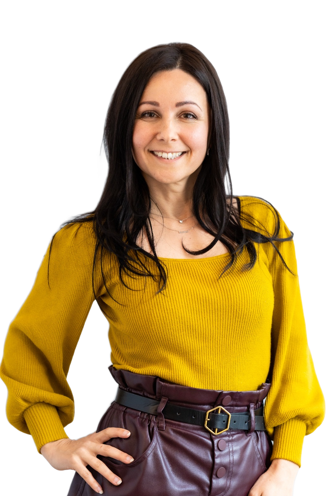 Goreti Gananca, founder of Grounded Beside You, standing with one hand on her hip and smiling.